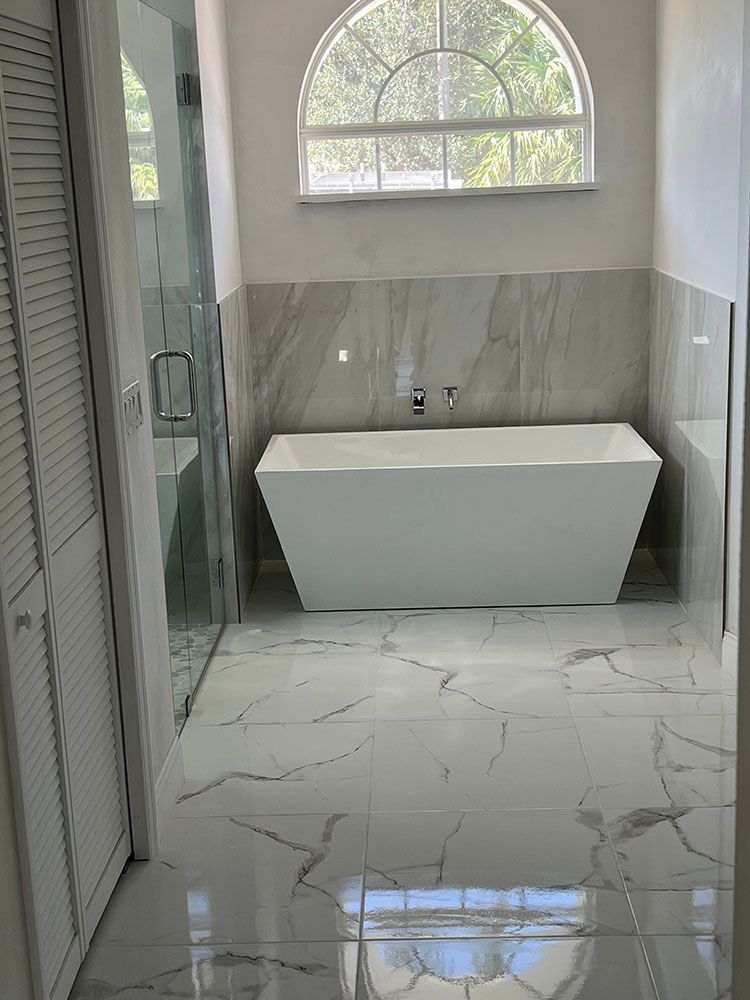 A bathroom with a bathtub and a window