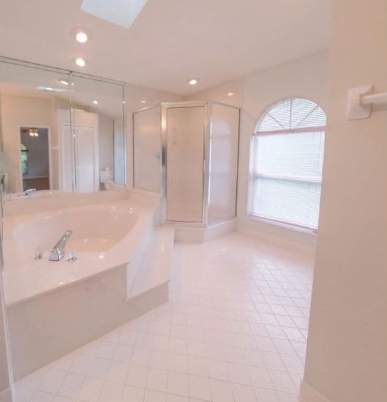 A bathroom with a bathtub and a shower