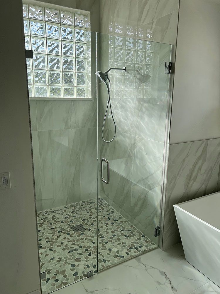 A bathroom with a walk in shower and a bathtub