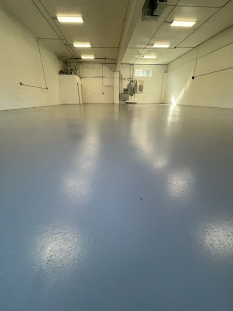 A large room with a blue floor and white walls.