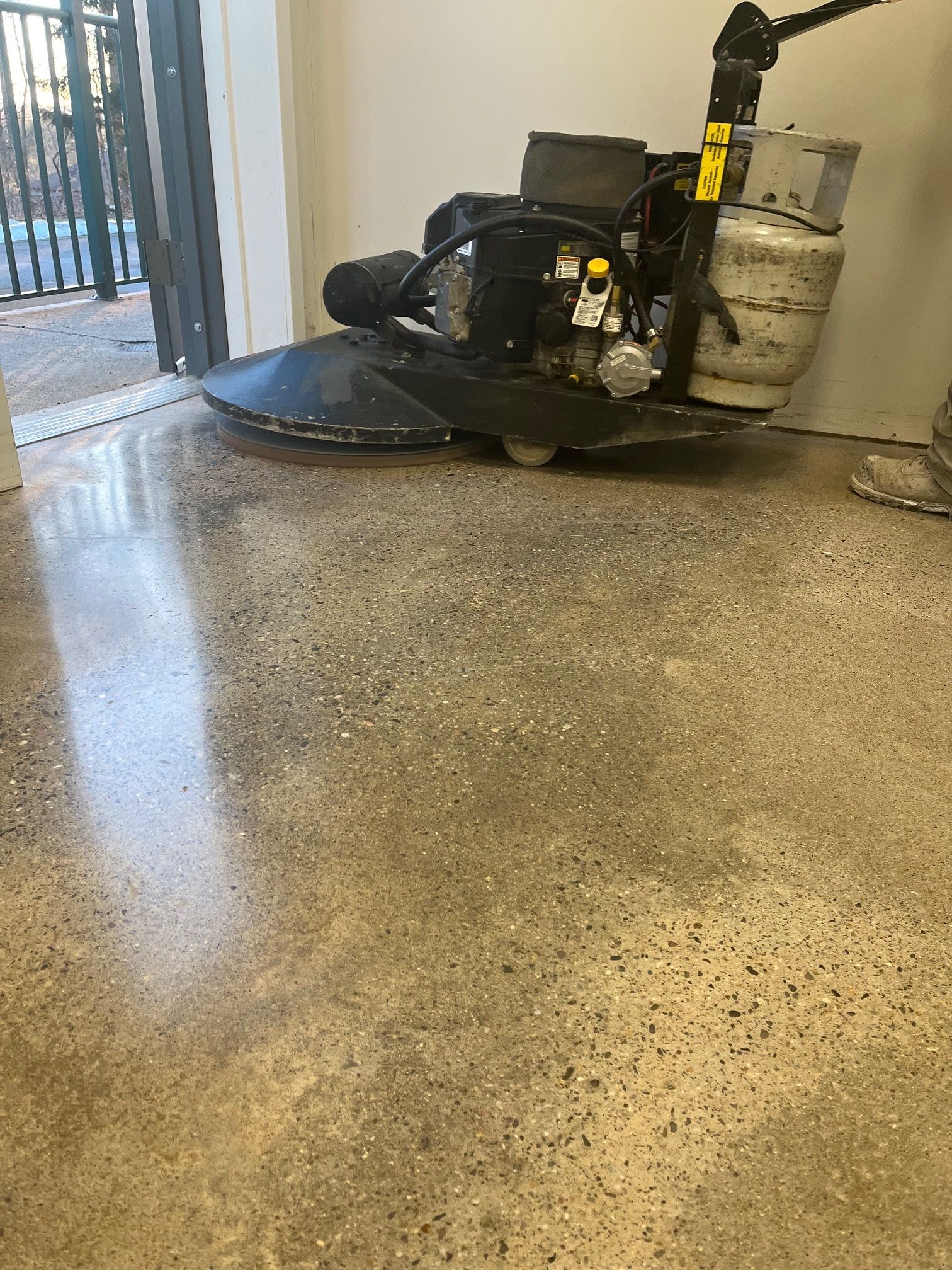 A machine is sitting on a shiny concrete floor.