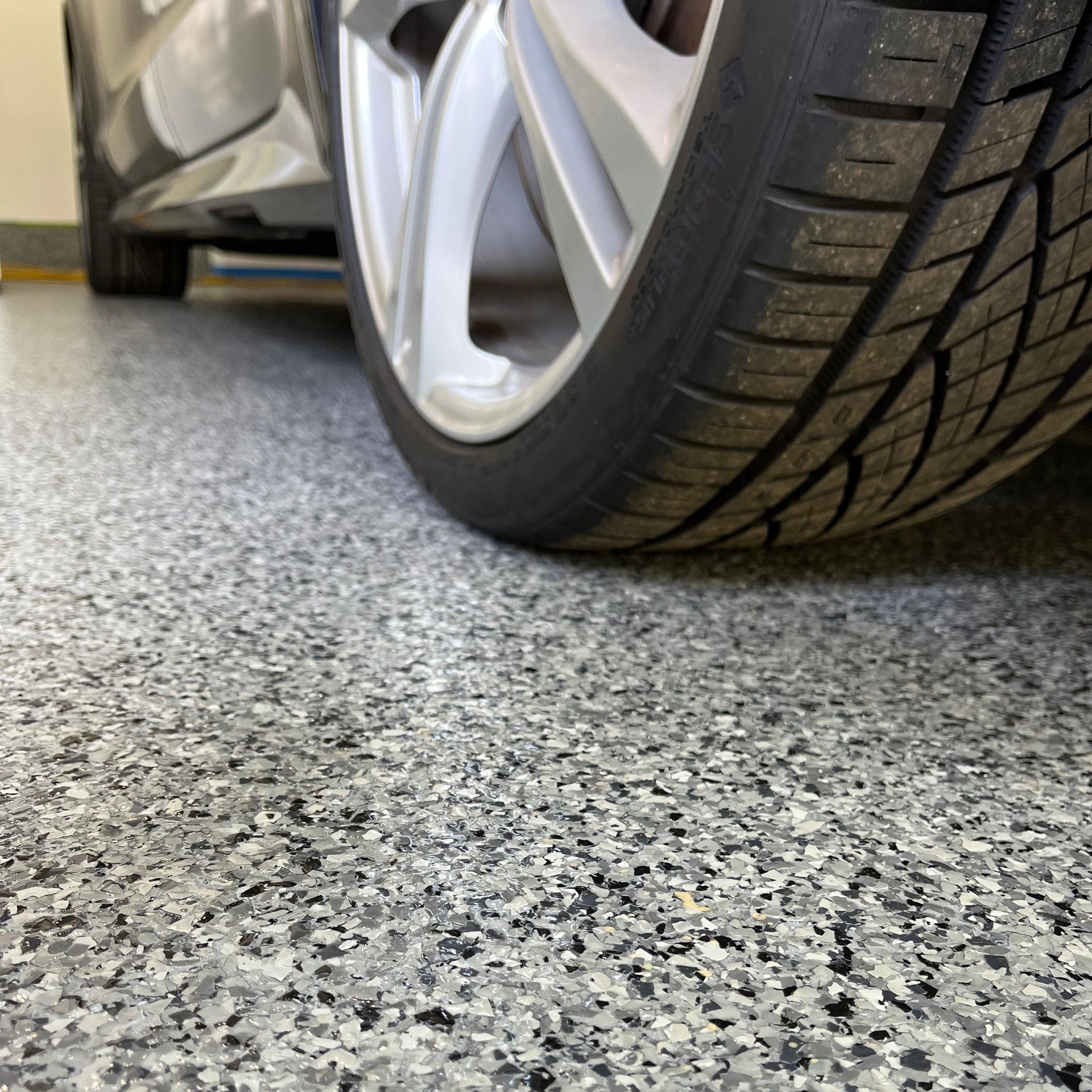 A close up of a car tire in a garage