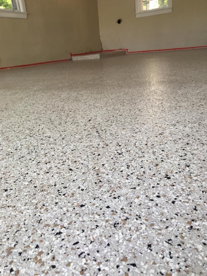 A garage floor with a lot of small stones on it.