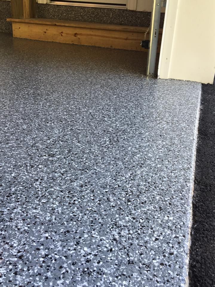 A close up of a gray concrete floor in a garage.