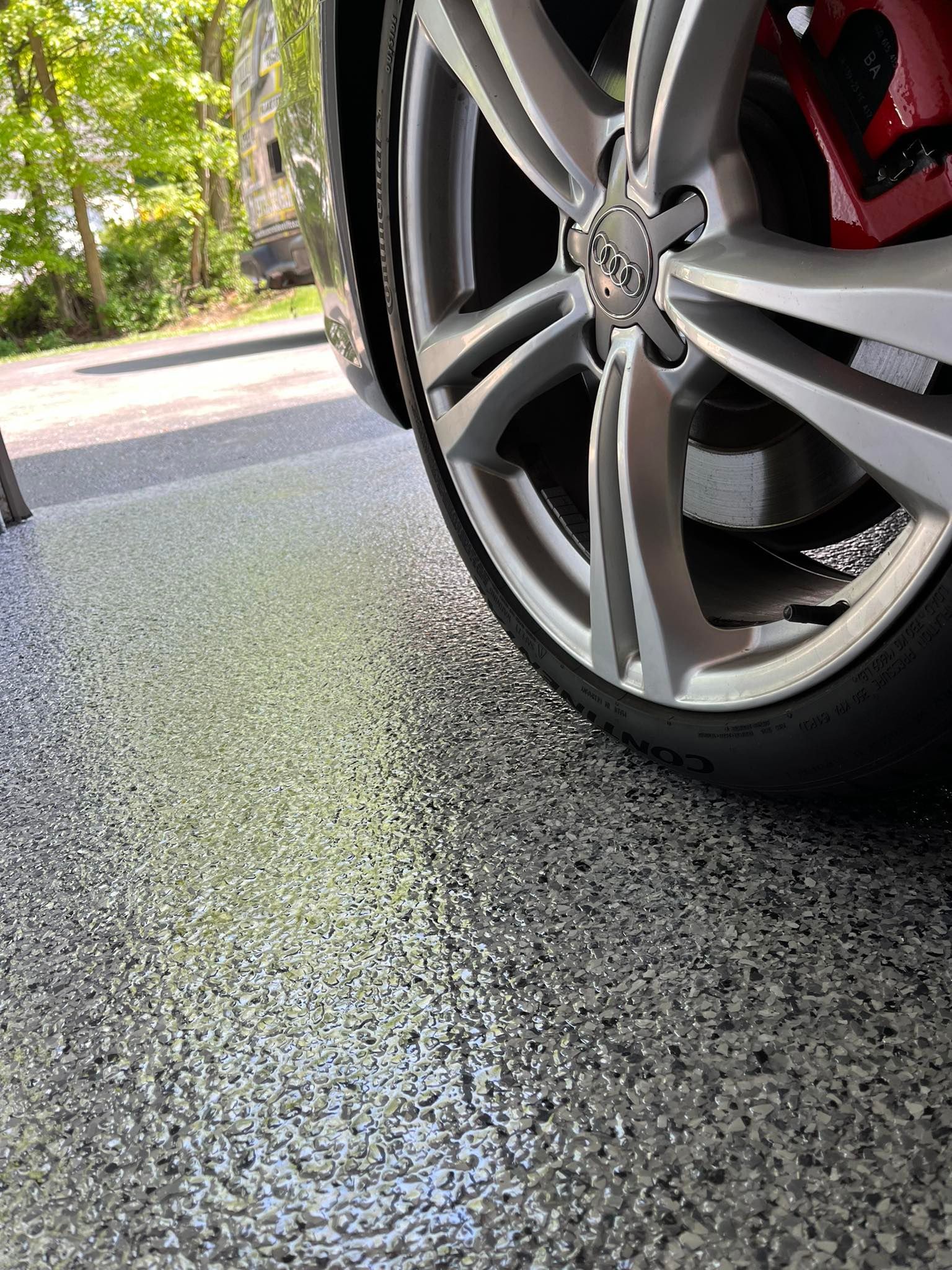 A close up of a car wheel on a garage floor.