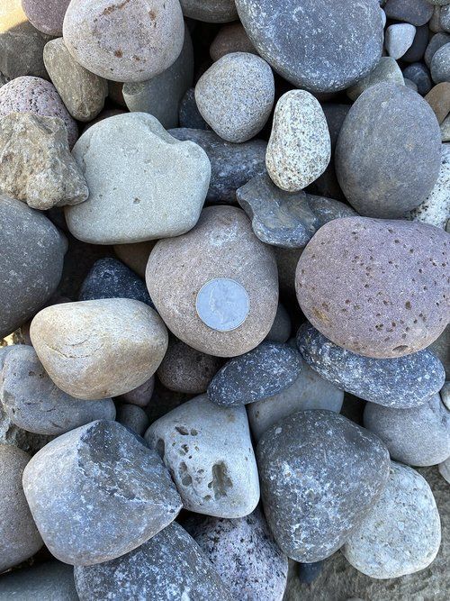 A pile of rocks with a heart shaped rock in the middle.