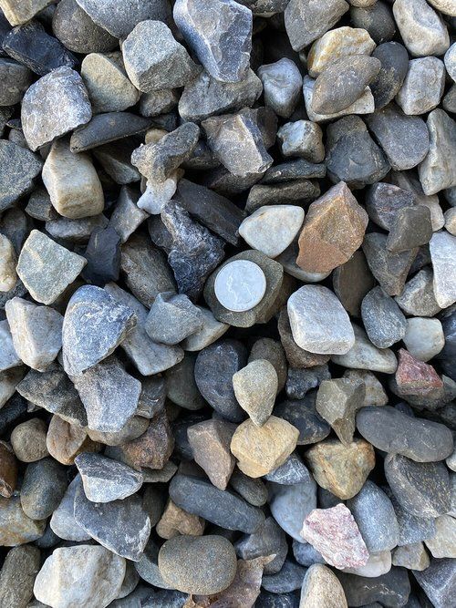 A pile of rocks with a coin in the middle.