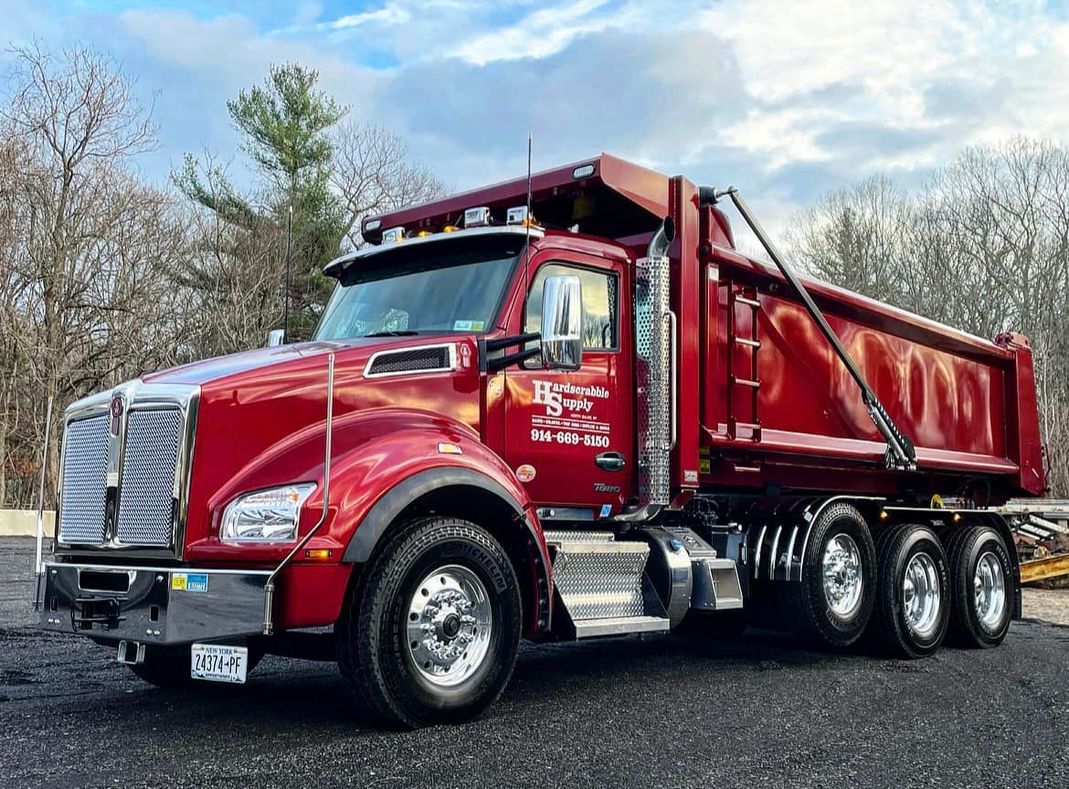 A pile of dirt is sitting next to a bulldozer bucket.