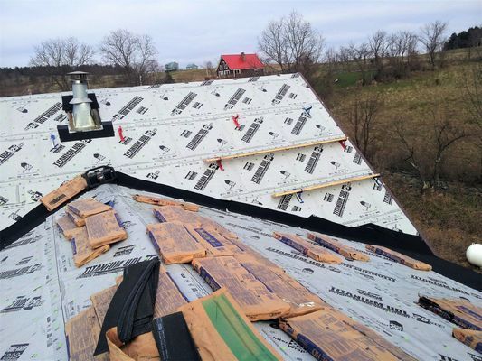 A roof is being built with a lot of pieces of paper on it