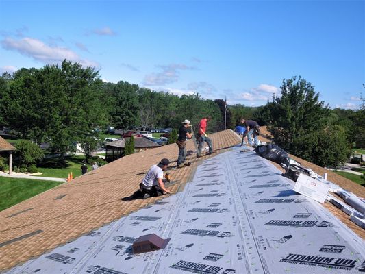 A group of people are working on a roof.