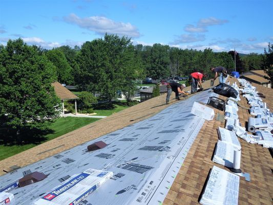 A group of people are working on a roof.
