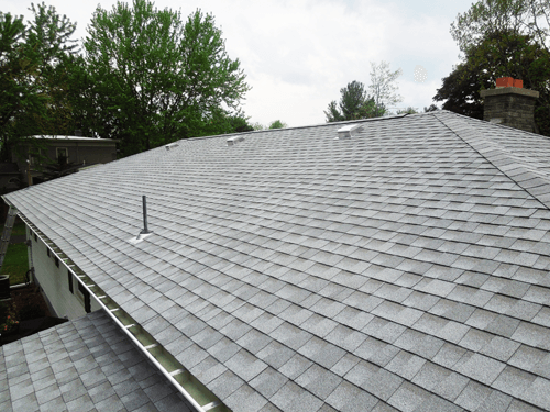 A roof of a house with a chimney on it