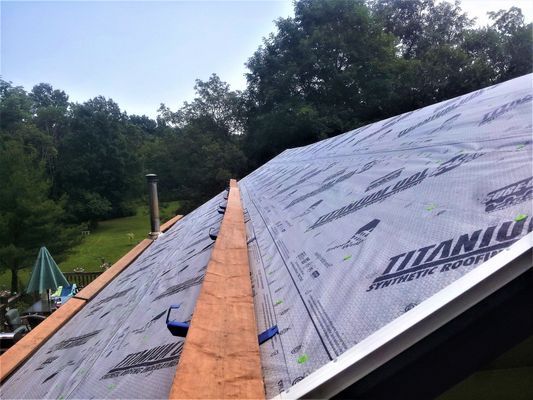 A roof is being covered with a titanium roofing material.