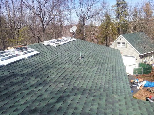 A green roof with a satellite dish on top of it
