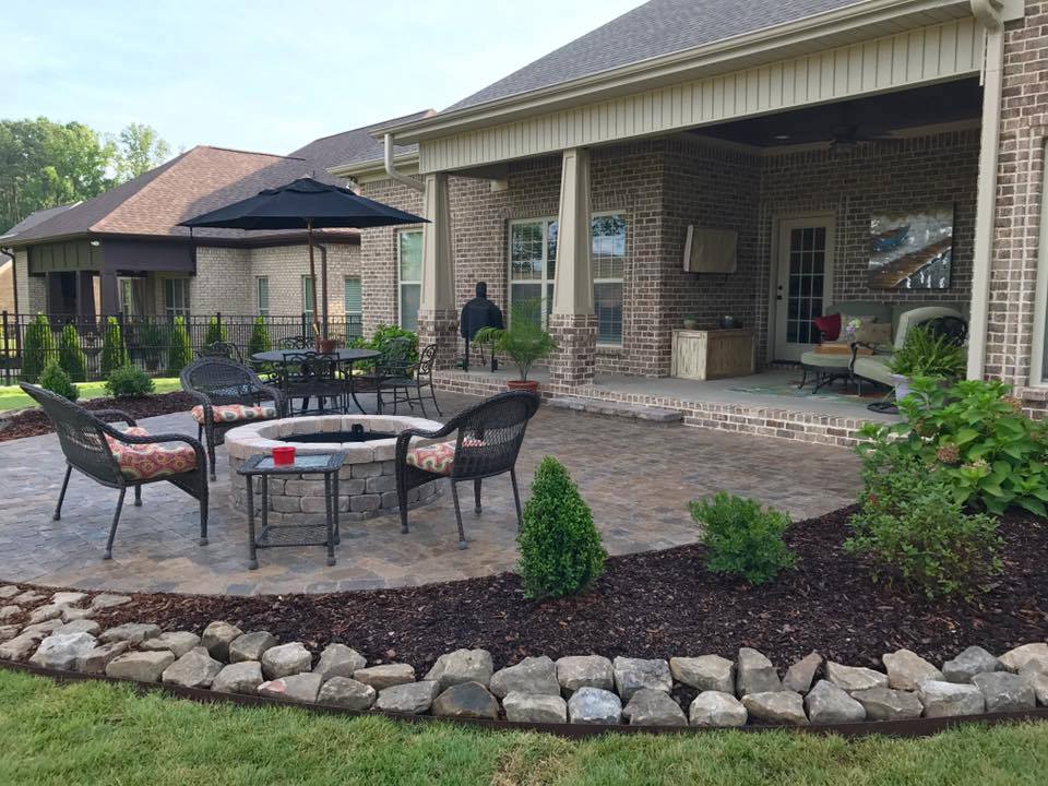 There is a fire pit in the middle of the patio.