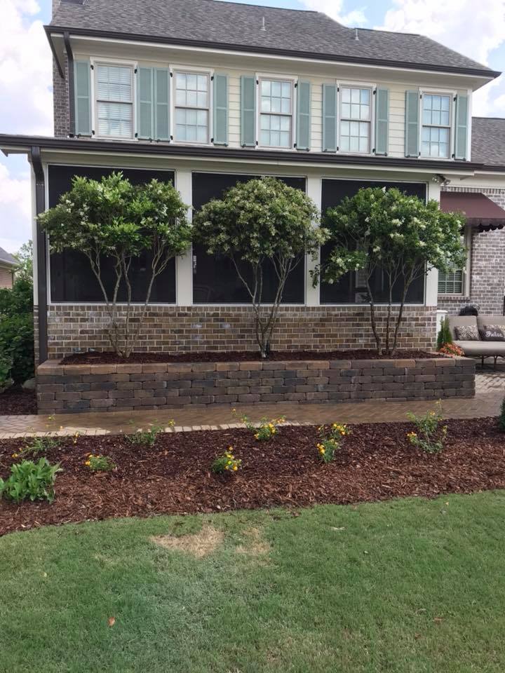 A large house with lots of windows and trees in front of it