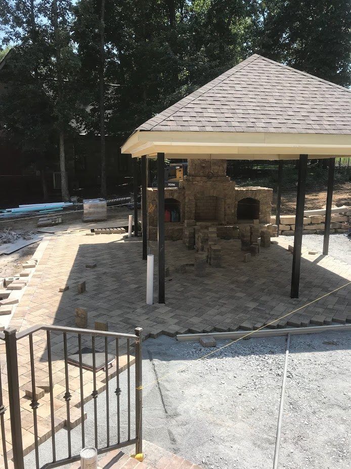 A gazebo is being built in the backyard of a house.