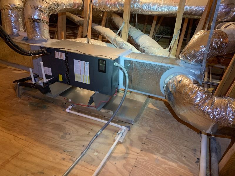 A room with a lot of pipes and wires hanging from the ceiling.