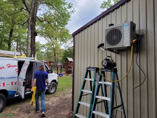 A man is standing next to a ladder and a van.
