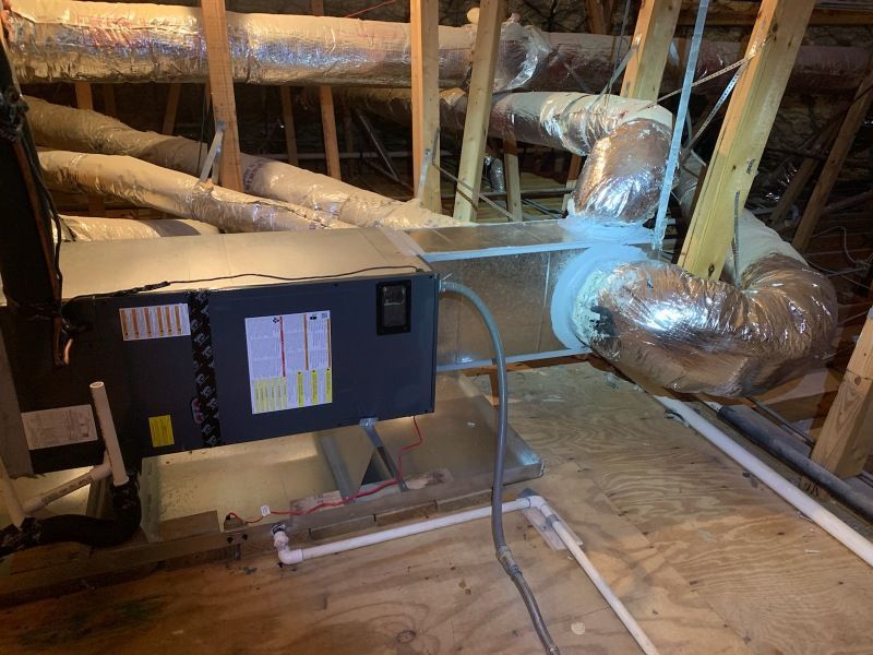 An air conditioner is sitting in the attic of a house.