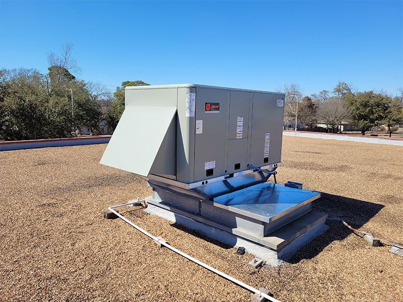 A large box is sitting on top of a dirt roof.