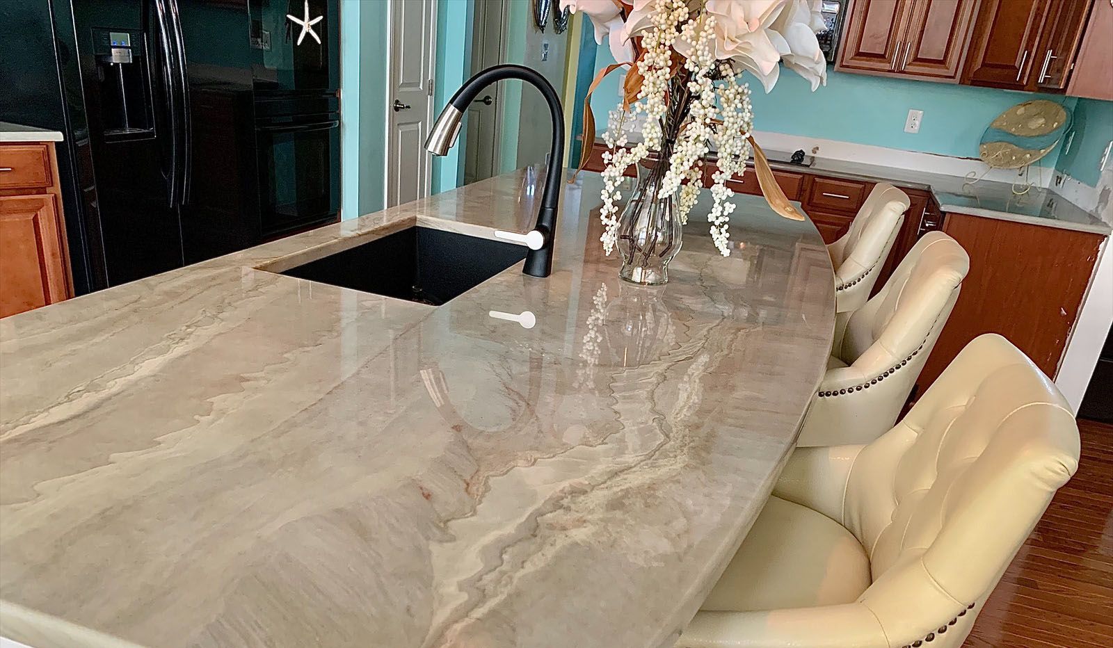 A kitchen with a large granite counter top and a sink.