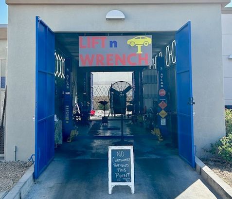 Blue garage with Lift n Wrench sign.