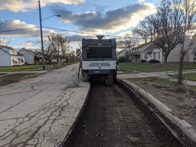 a machine is working on the side of a road