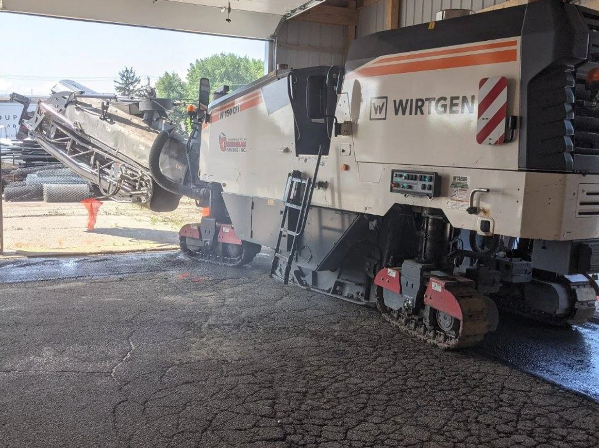 a large machine is sitting in a garage under a bridge