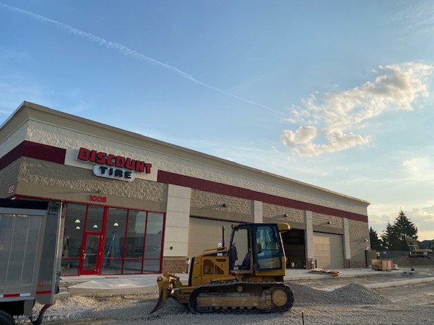 a bulldozer is parked in front of a building