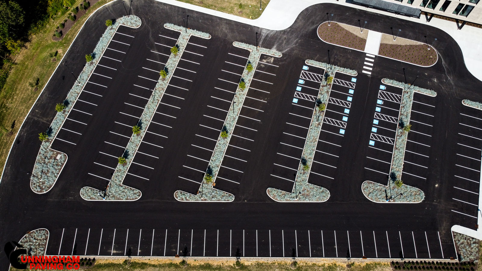 an aerial view of a parking lot with cars parked in it