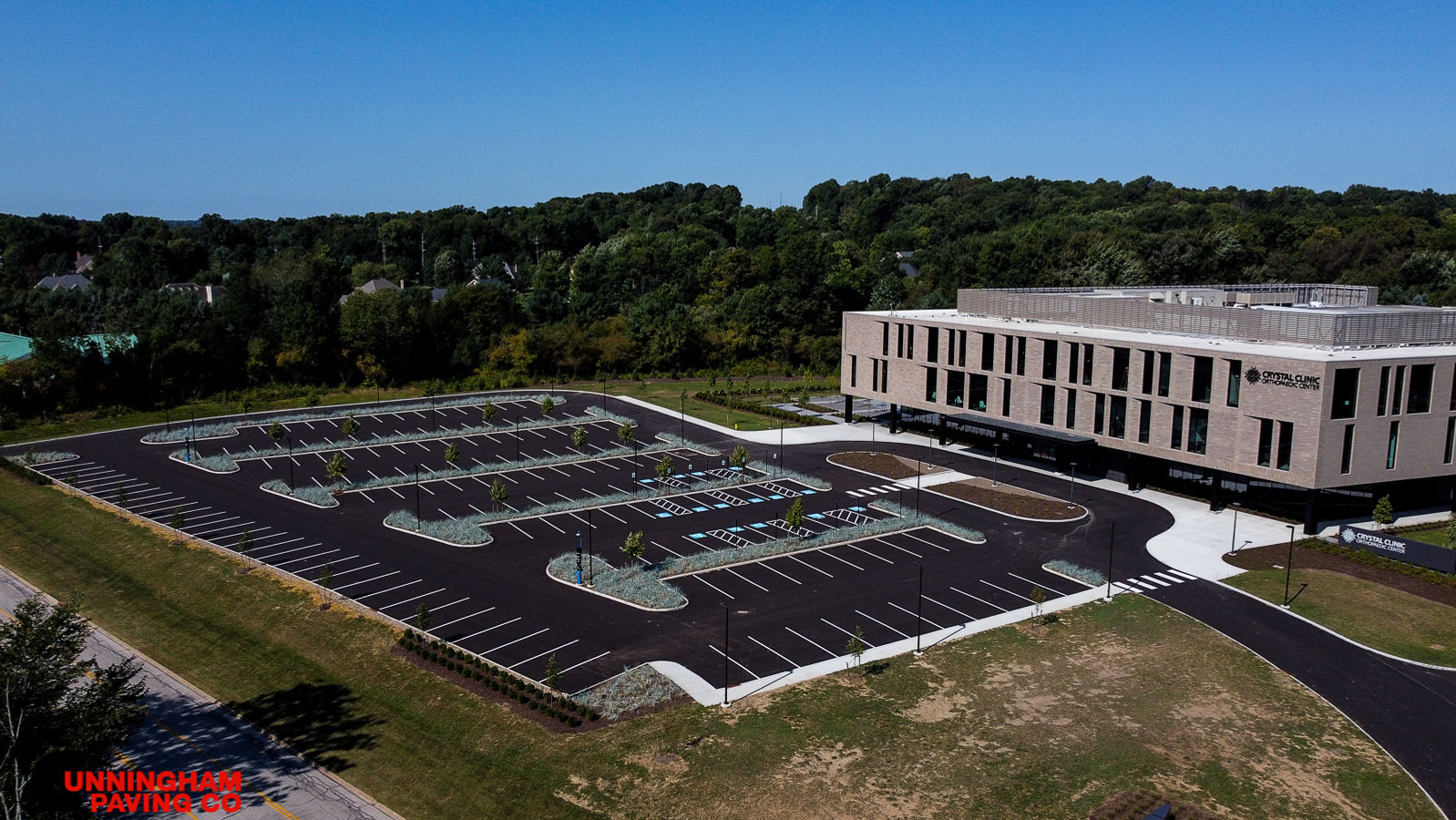 an aerial view of a large building with a lot of parking spaces in front of it