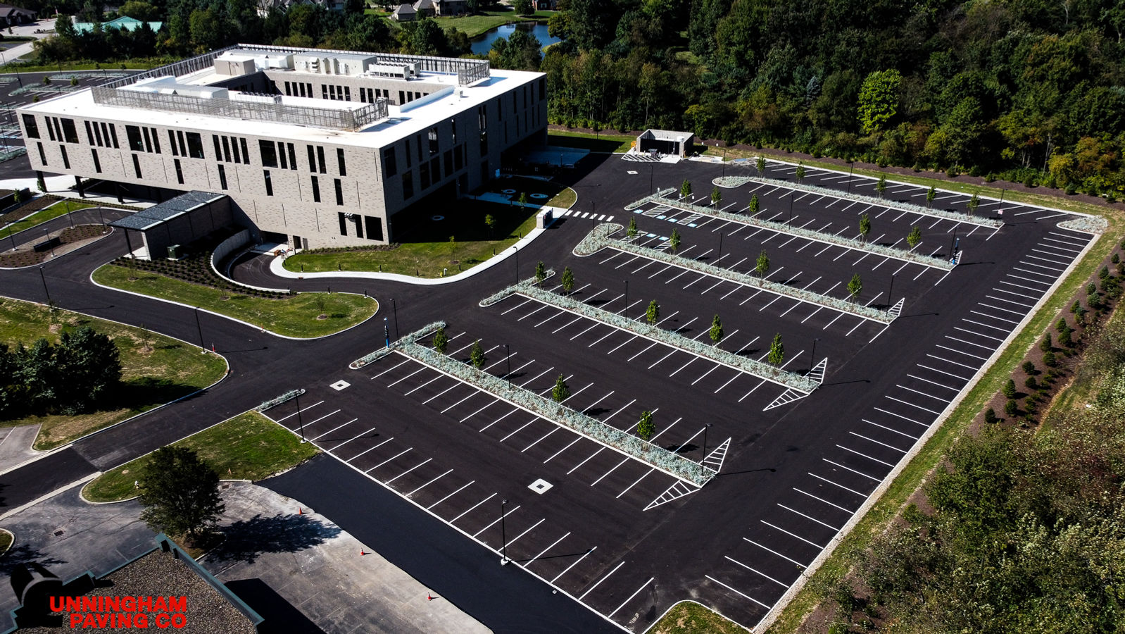 an aerial view of a parking lot in front of a large building