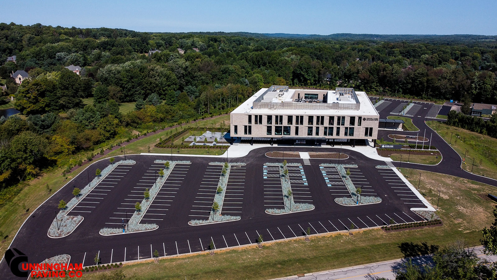 an aerial view of a large building with a lot of parking spaces in front of it .