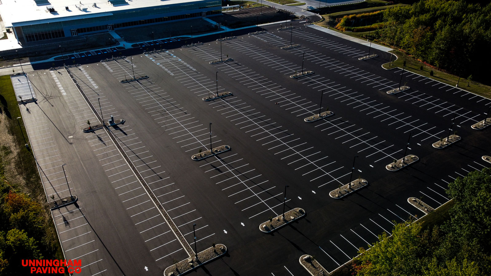 an aerial view of an empty parking lot in front of a large building