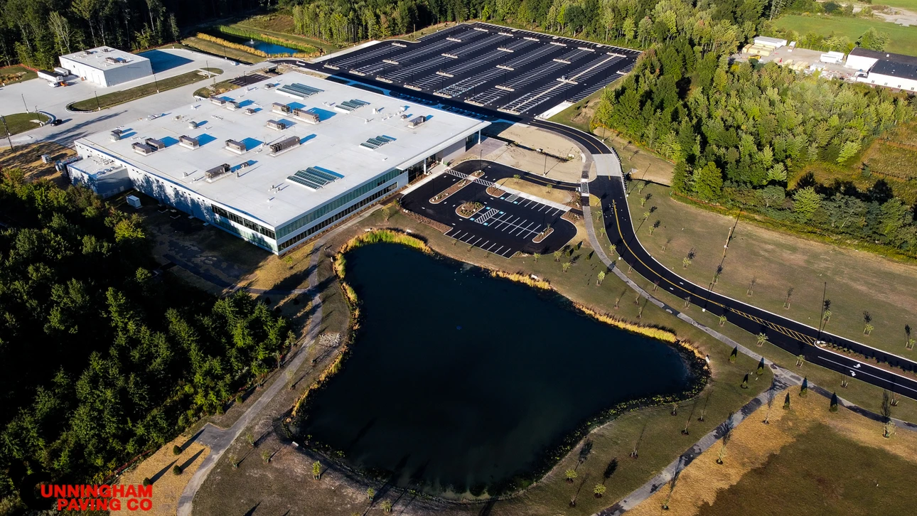 an aerial view of a large parking lot next to a lake
