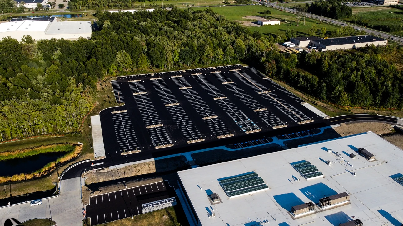 an aerial view of a large building with solar panels on the roof