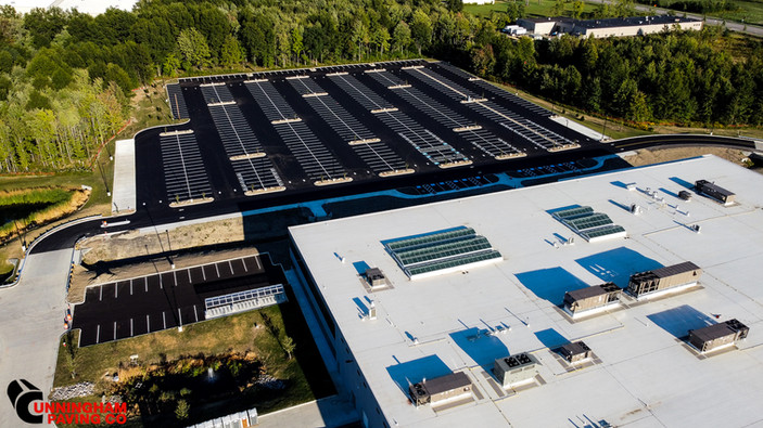 an aerial view of a large building with solar panels on the roof