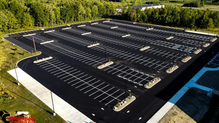 an aerial view of a large parking lot filled with cars