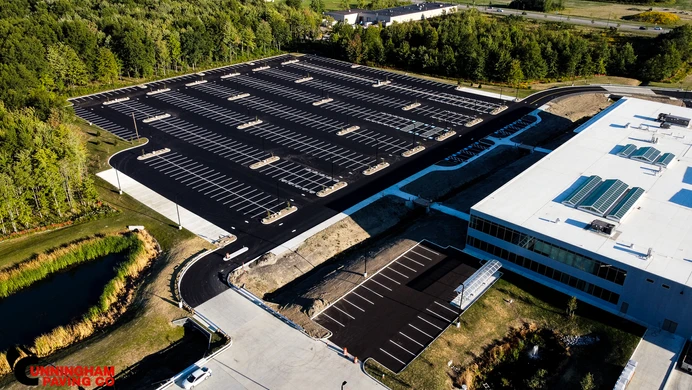 an aerial view of a large building with solar panels on the roof