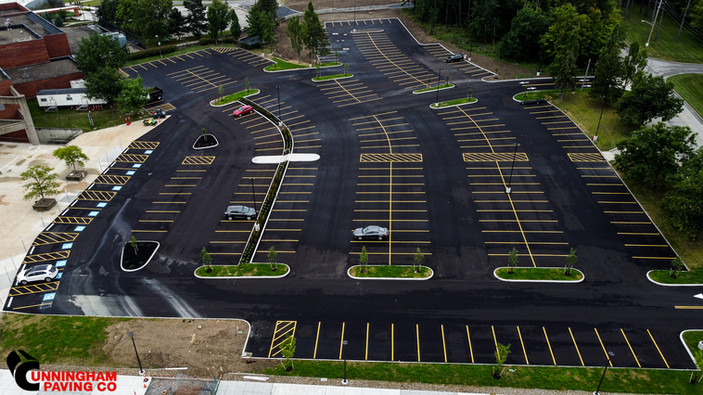 an aerial view of a parking lot with cars parked in it