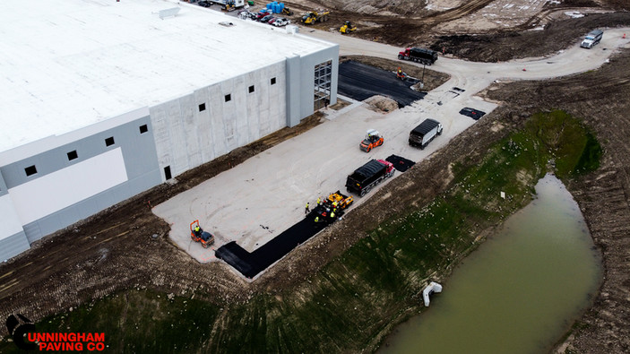 an aerial view of a large building under construction next to a body of water