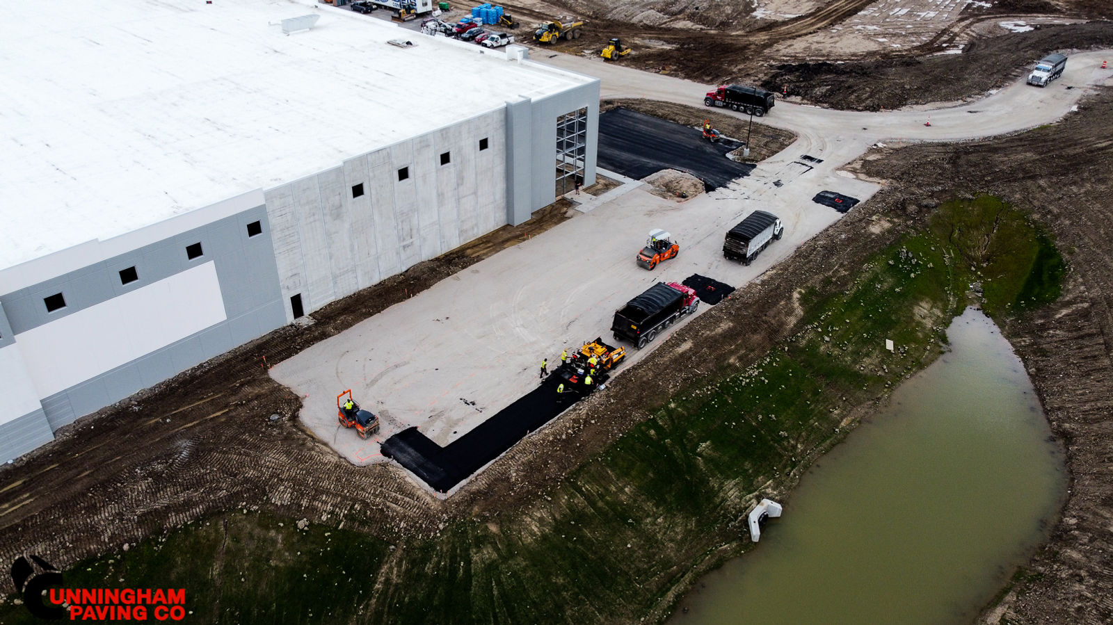 an aerial view of a building under construction next to a body of water