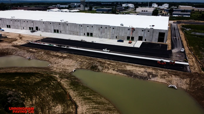 an aerial view of a large building with a white roof