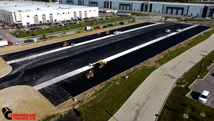 an aerial view of a road that is being paved