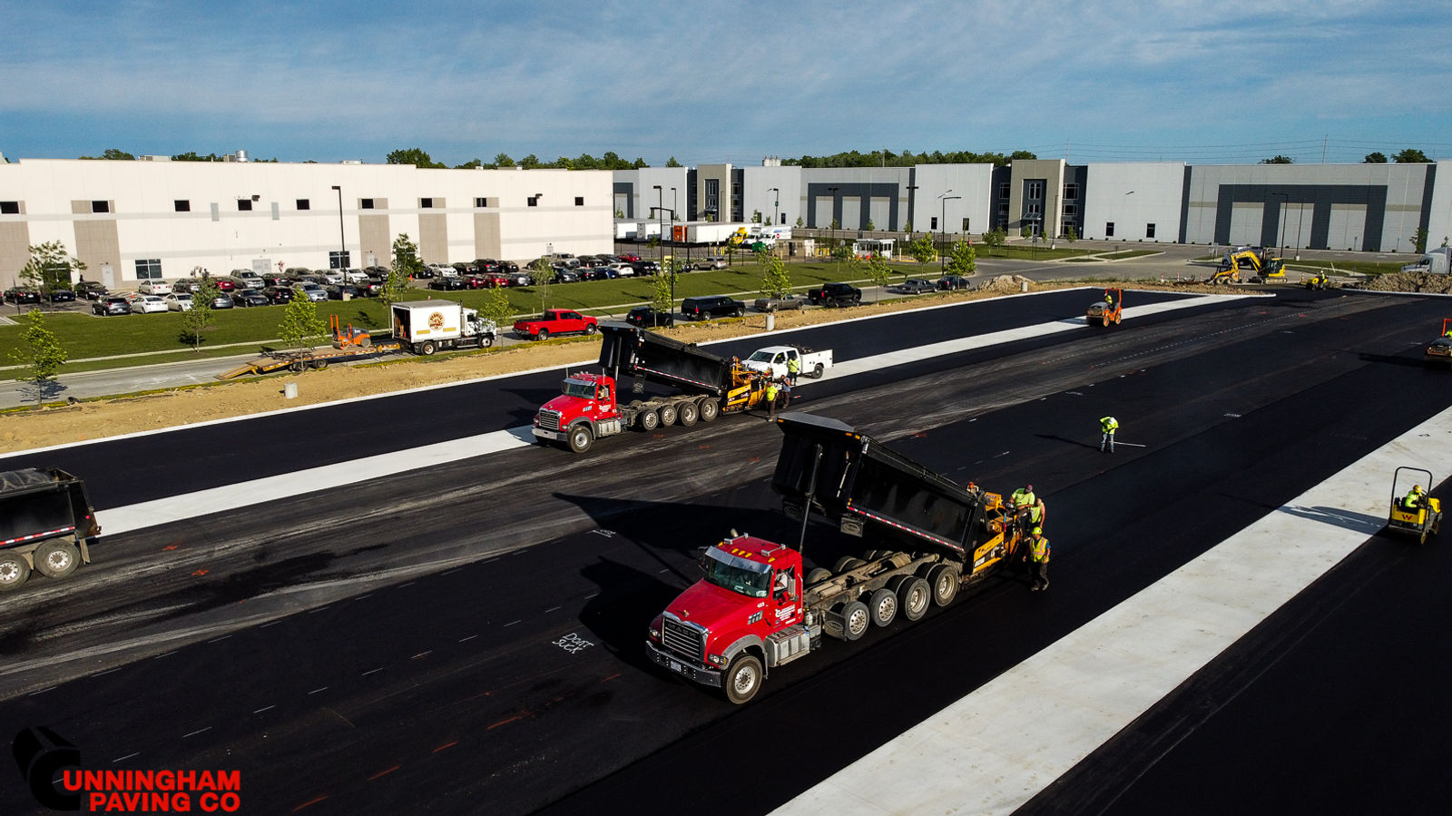 a group of trucks are driving down a road