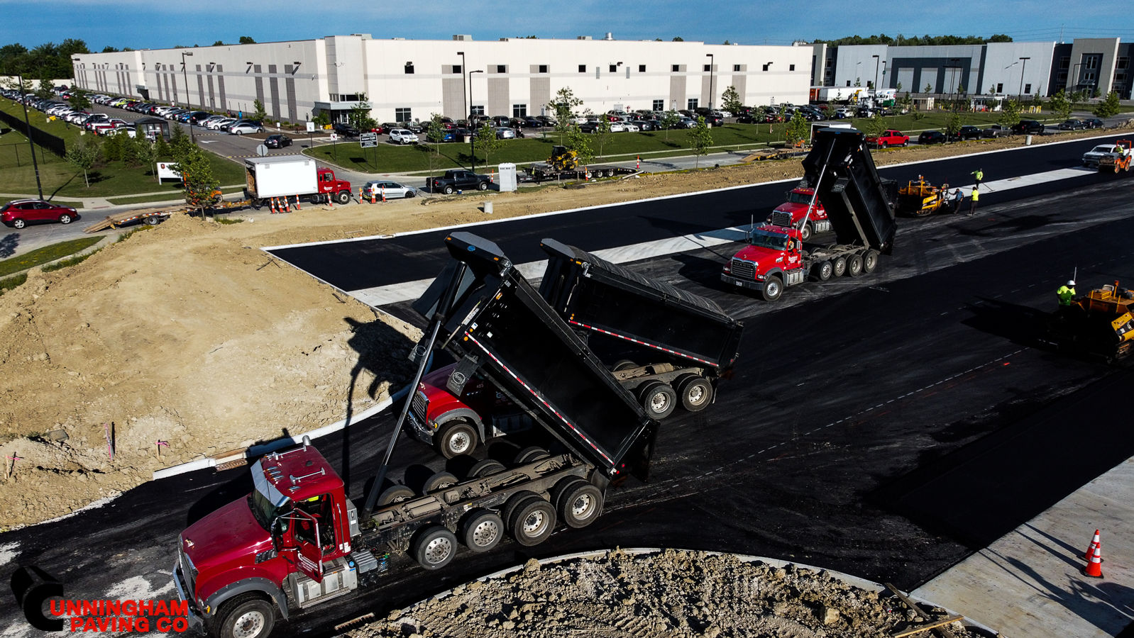 a red dump truck is driving down a construction site