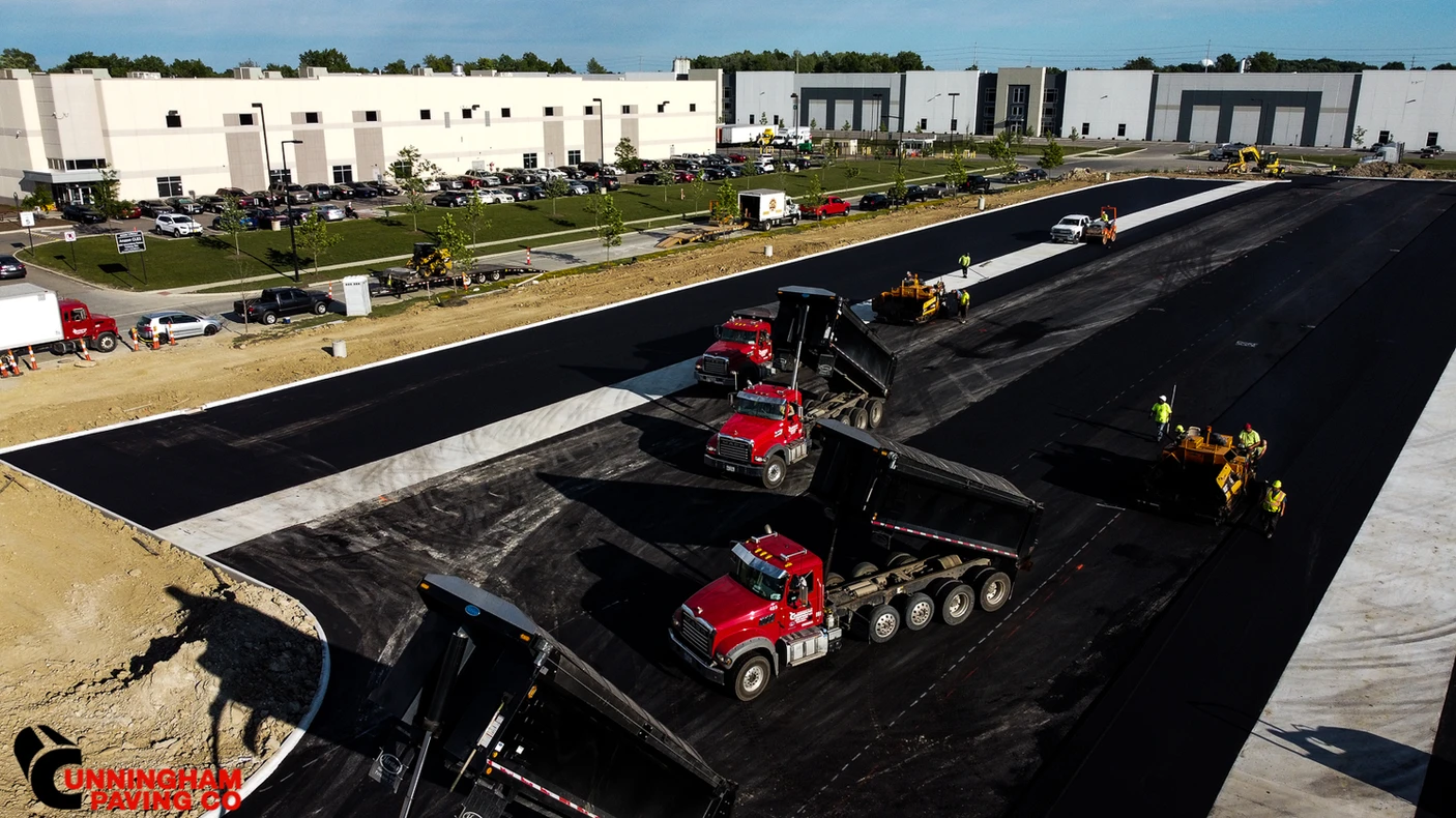 an aerial view of a road that is being paved