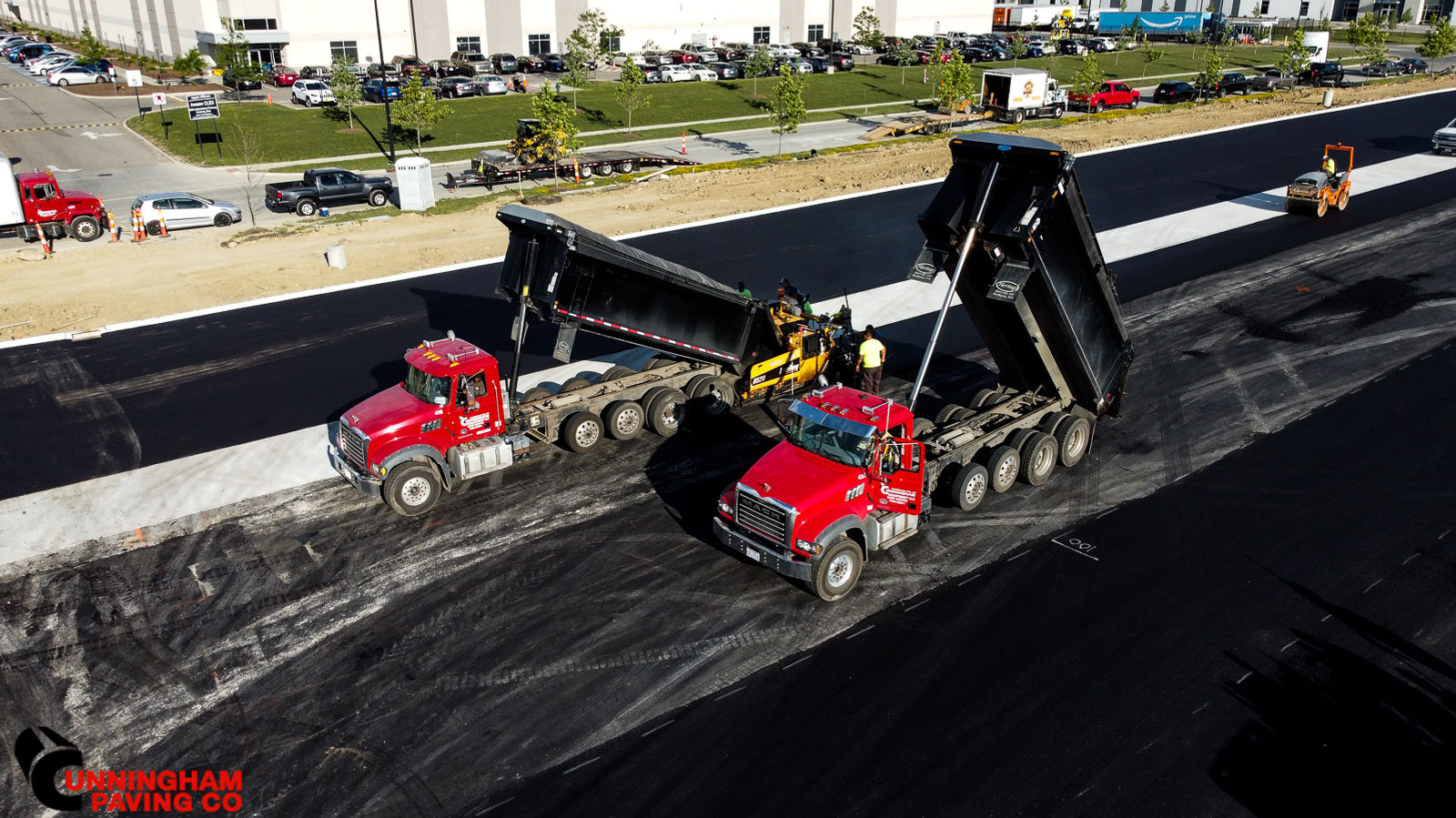 a couple of dump trucks are driving down a road
