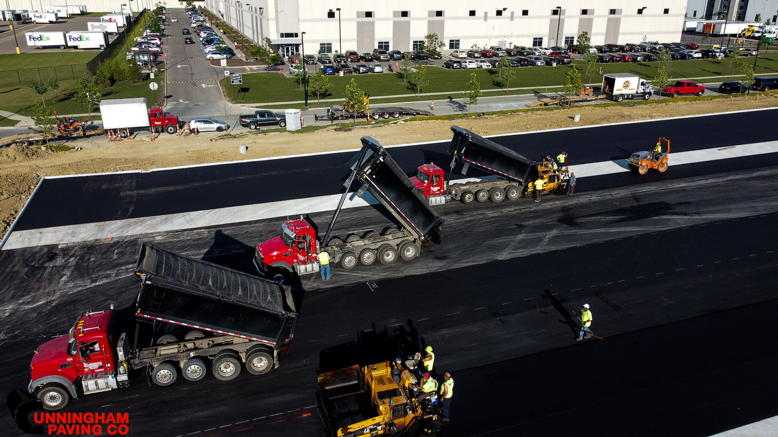 an aerial view of a construction site with trucks and workers
